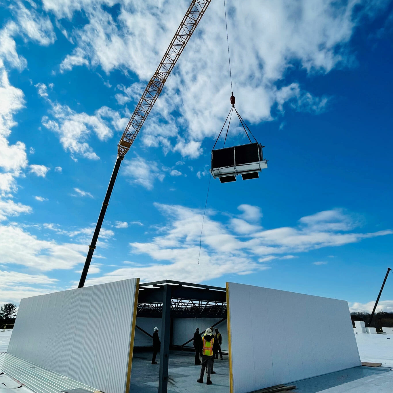ARC Mechanical installs a new refrigeration unit on a building roof